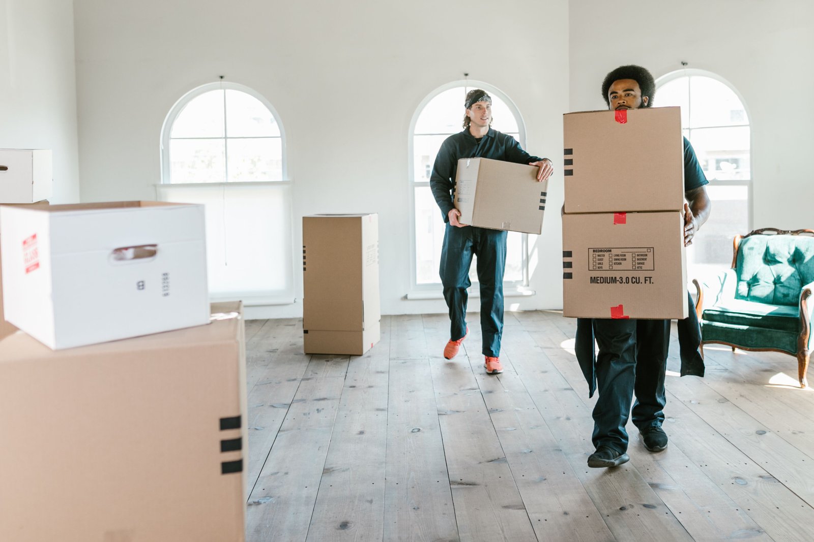 Movers lifting furniture into a new home